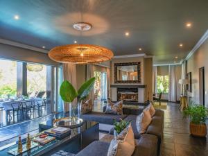 a living room with a couch and a table at Luxury Villa Umdoni - Eden Rock Estate, Pennington in Pennington