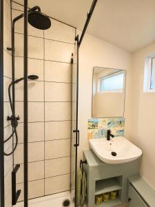 a bathroom with a sink and a shower at The Coastal Cosy, St Merryn, Padstow in Saint Merryn +20 photos