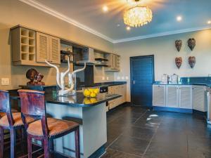a large kitchen with a island with a counter top at Luxury Villa Umdoni - Eden Rock Estate, Pennington in Pennington