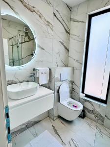 a bathroom with a toilet and a sink and a mirror at Villa Koćuša in Ljubuški +40 photos