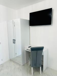 a desk with a chair next to a white cabinet at Villa Koćuša in Ljubuški