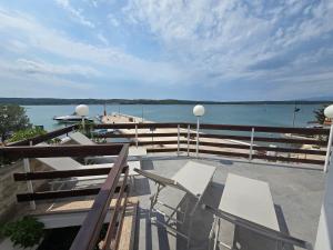 a balcony with chairs and a view of the water at Smiljana 36 in Klimno