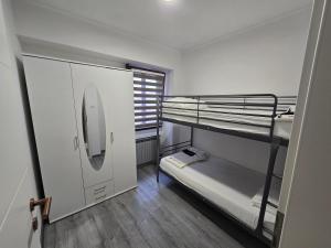 a small room with two bunk beds and a window at Smiljana 36 in Klimno