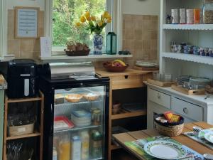 a kitchen with an open refrigerator with food inside at Bikes and Breakfast, City Farmer Amsterdam a Guesthouse with Free Parking in Amsterdam