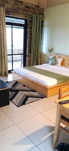 a bedroom with a wooden bed with a window at Rudraa Himalayan Retreat in Hawālbāgh