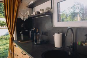a kitchen with a sink and a window at Statek ráj Netvořice, Tiny house and Farm Experience in Netvořice
