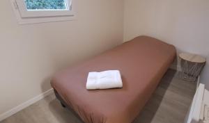 a bed with a white towel on it in a room at Domaine des Epinettes in Saint-Romain-de-Jalionas +31 photos