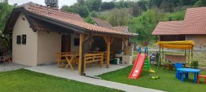 a house with a playground with a table and a play set at TEA Apartmani in Bajina Bašta