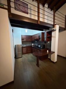 a large kitchen with a table and a refrigerator at Eldorado Apartments F2P3 Wattala in Alwis Town