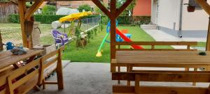 a backyard with a playground with a swing at TEA Apartmani in Bajina Bašta +22 photos