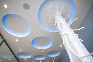 a painting of a tree in a room with blue circles at Hotel Boutique La Mar - Adults Only in Peniscola