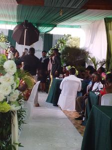 a couple walking down the aisle at a wedding at Icon Hotel in Kampala