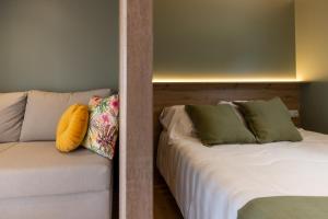 a couch with two pillows on it in a room at Camping As Cancelas in Santiago de Compostela