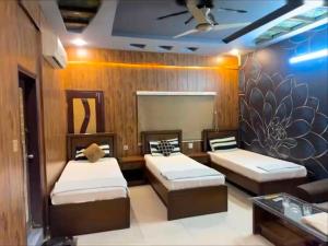 a room with three beds in a room at Hotel Serena in Hyderabad +15 photos