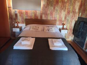 a bedroom with a bed with two pillows and a tv at Yahweh temporarios in Río Grande