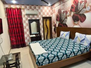 a bedroom with a bed and a mirror at Hotel Serena in Hyderabad