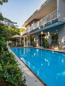 a swimming pool in front of a house at Palmtree Luxury Villa Eden Rock Estate, Pennington in Pennington