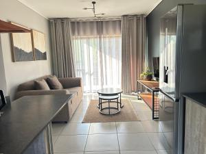 a living room with a couch and a table at 161 green valley in Boschrand