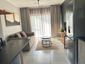 a living room with a couch and a table at 161 green valley in Boschrand