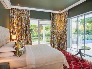 a bedroom with a bed and a large window at Palmtree Luxury Villa Eden Rock Estate, Pennington in Pennington +26 photos