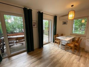 a dining room with a table and chairs and sliding glass doors at Przylądek Werlas in Werlas