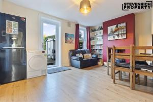 a living room with a washer and dryer at Group Stays, 4 Bedroom, Spacious Home in BS4, Van & Car Parking, Sleeps 7 in Bristol