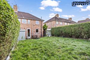 a yard in front of a brick house at Group Stays, 4 Bedroom, Spacious Home in BS4, Van & Car Parking, Sleeps 7 in Bristol