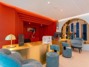 a salon with blue chairs and a reception desk at Mercure Shéhérazade Rabat in Rabat