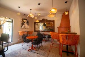 a dining room with orange chairs and a table at Hotel Casa Blanca in Ajijic