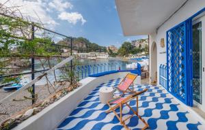 a balcony with two chairs and a view of the water at La Prua in Taormina