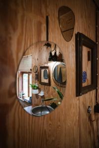 a mirror on a wooden wall with a sink at Wdech Wydech in Chełsty