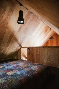 a bed in a room with a wooden ceiling at Wdech Wydech in Chełsty