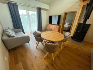 a living room with a table and chairs and a television at Hotel Terasa in Frýdek-Místek