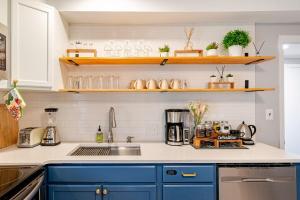 a kitchen with blue cabinets and a sink at Downtown WS bungalow Close to Everything in Winston-Salem