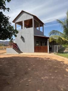 a building with a staircase in front of it at Pousada Recanto dos Buritis in Manhã