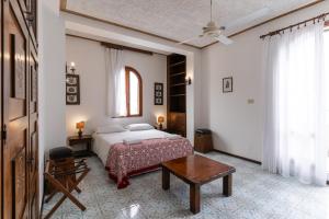 a bedroom with a bed and a table in it at Hotel Carasco in Lipari +87 photos