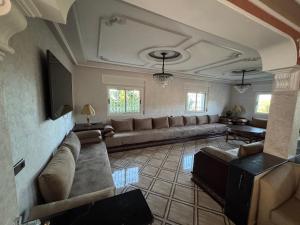 a living room with a couch and a tv at villa victoria in Tétouan