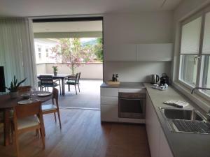 a kitchen and dining room with a table and chairs at Gardena Living in Ponte Gardena