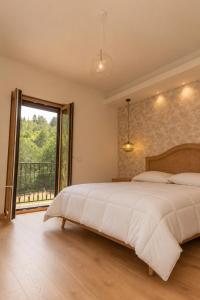 a bedroom with a large bed and a large window at Chiarelli Mountain Suite in Camigliatello Silano +33 photos