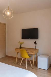 a bedroom with a desk and a yellow chair at Chiarelli Mountain Suite in Camigliatello Silano