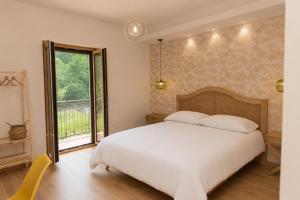 a bedroom with a large white bed and a window at Chiarelli Mountain Suite in Camigliatello Silano