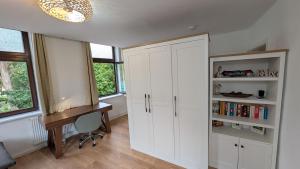 a home office with white cabinets and a desk at Ferienwohnung Lehmann in Wolfenbüttel