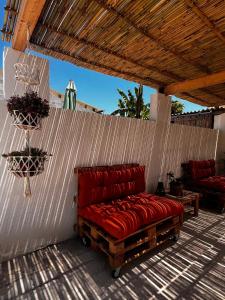 a red couch sitting on top of a patio at PEACE ROOMS in Pozzallo
