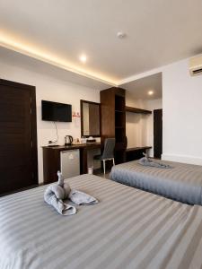 a hotel room with a stuffed animal on a bed at Doze Bangla in Patong Beach