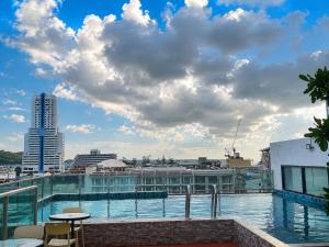 a swimming pool on the roof of a building at Doze Bangla in Patong Beach