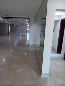 an empty room with glass doors in a building at Terraza Frontera Hotel in Pedro Juan Caballero