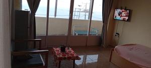 a room with a table and a view of the ocean at EcoDream Lodge in Port Mathurin