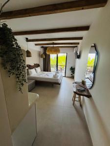 a bedroom with a bed and a couch in a room at Hotel marmaras in Neos Marmaras