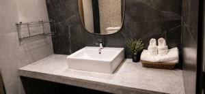 a bathroom with a white sink and a mirror at Chomphu Phukha Resort-Mountain View Nan in Pua +26 photos