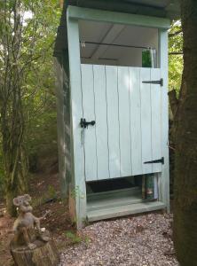 a out house with a door in the woods at Rowan retreat,Renwick, Penrith,CA10 1LA in Penrith +11 photos